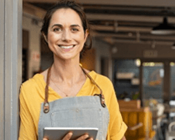 Franchise owner holding tablet – scalable marketing for franchises powered by NOVA Advertising.