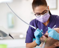 Dentist performing a dental procedure – digital marketing solutions for dental practices by NOVA Advertising.