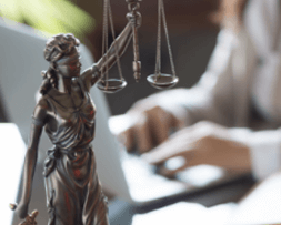 Lady Justice statue with legal professional in background – law firm marketing expertise from NOVA Advertising.
