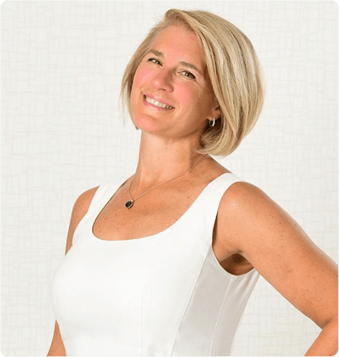 Ivy Horan from MGI Corporate Gifts smiling confidently in a white dress