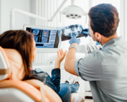 Oral surgeon preparing for a procedure in a sterile surgical setting, representing surgical dental marketing