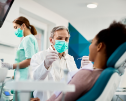 Orthodontist Applying Braces | Cosmetic Dental Marketing
