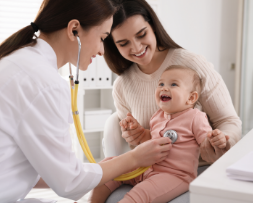 Pediatric doctor with a cheerful child patient, illustrating pediatric and family medicine marketing