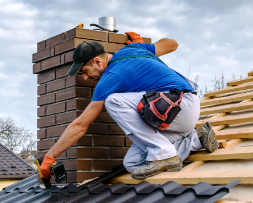 Roofer securing shingles on a house rooftop, representing lead generation for roofing companies