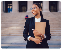 Confident female lawyer holding legal documents outside a courthouse