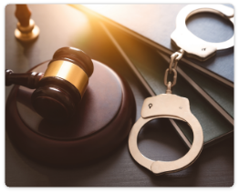 Gavel and handcuffs on a desk symbolizing criminal law and justice